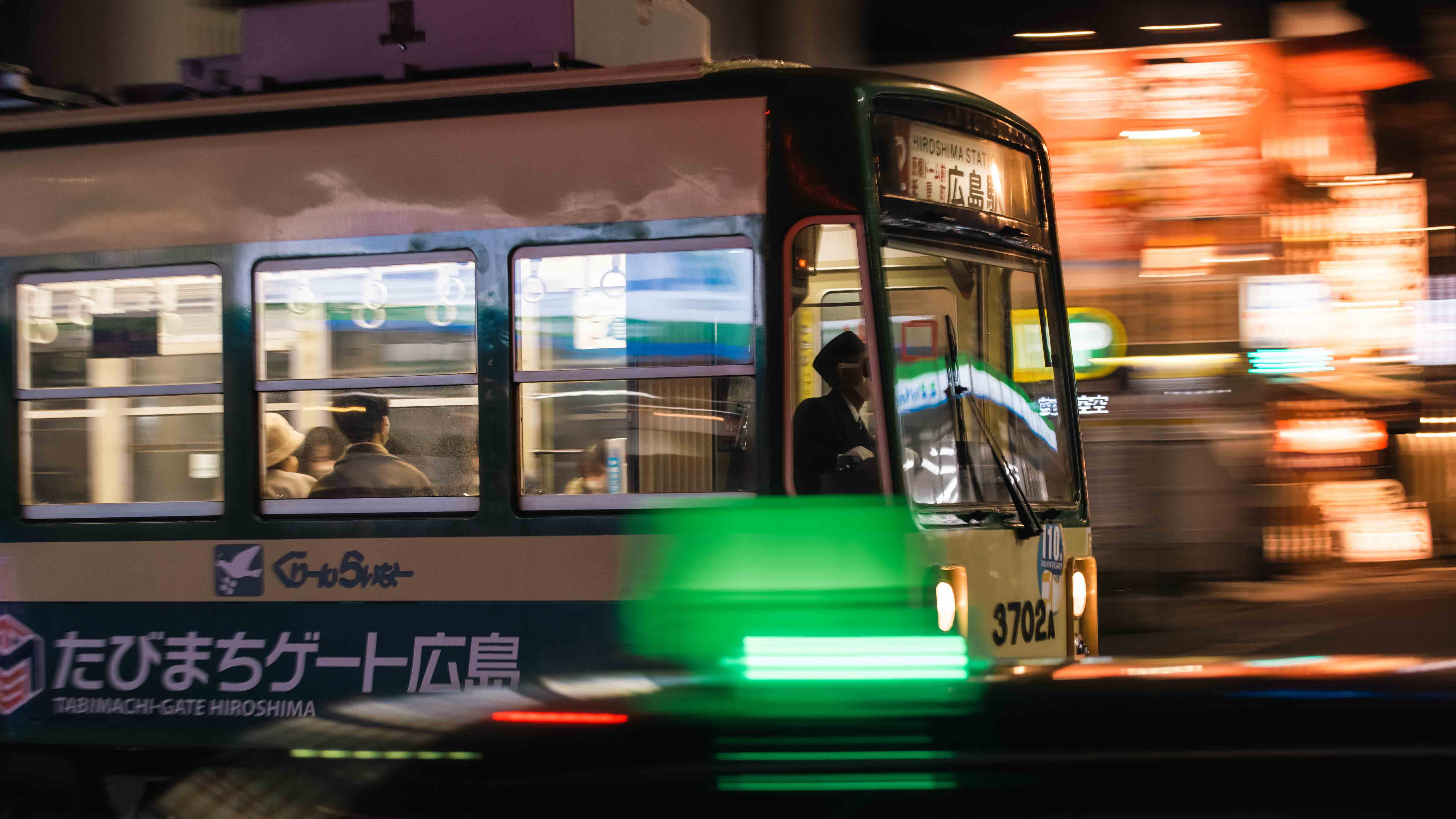 Bright-greeb bamboo tree stands alone, with bits of snow on it